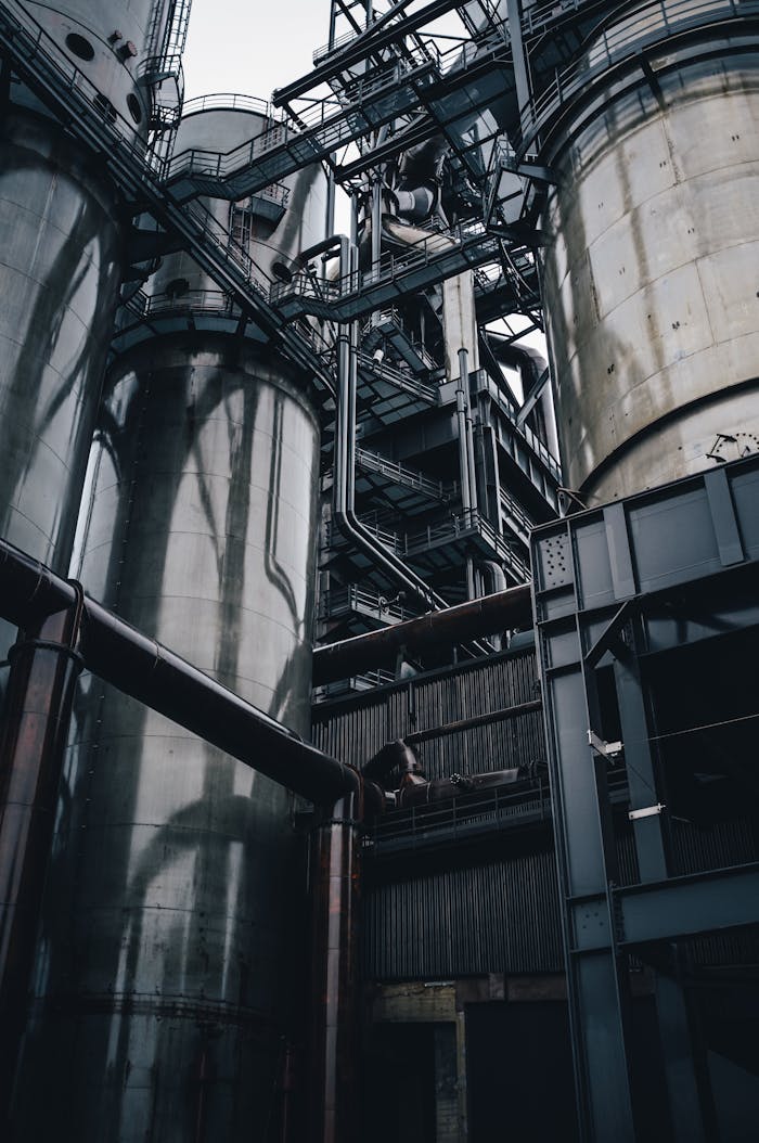 About Low angle view of towering industrial silos in Luxembourg, showcasing modern production infrastructure.